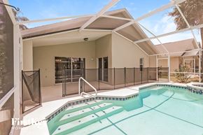 Haines City house for rent - A pool in a house with a glass wall.