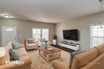 Charlotte house for rent - A living room with a brown couch and a wooden coffee table.