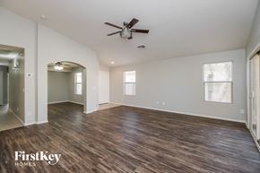San Tan Valley house for rent - A spacious room with wood flooring and a ceiling fan.