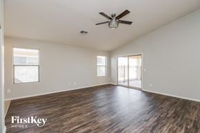 San Tan Valley house for rent - A spacious room with wooden flooring and a ceiling fan.
