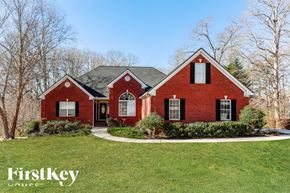 Dacula house for rent - A red brick house with a black door and windows.