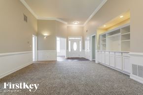 Dacula house for rent - A spacious room with a carpeted floor and white walls.