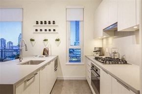 Burnaby apartment for rent - A modern kitchen with a view of the city outside the window.