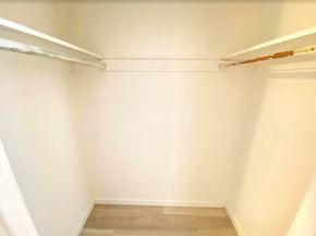 Merced house for rent - A white closet with a wooden floor and a white shelf.