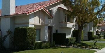 Palm Desert apartment for rent - A house with a red tile roof and a white exterior.