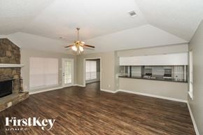 Cordova house for rent - A spacious room with wood flooring and a ceiling fan.