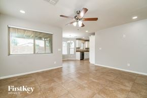 Gilbert house for rent - A spacious room with a fan and tiled flooring.