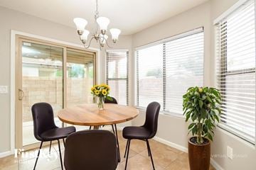 Gilbert house for rent - A dining room with a round table and chairs.