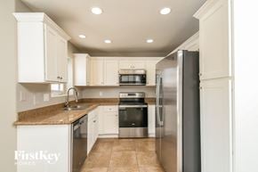 Gilbert house for rent - A kitchen with a refrigerator, sink, and microwave.