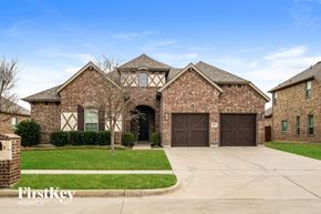Midlothian house for rent - a large brick house with brown garage doors
