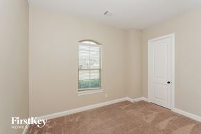 Midlothian house for rent - a bedroom with an arched window and a white door