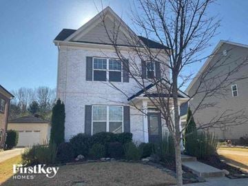 Charlotte house for rent - a white house with a tree in front of it