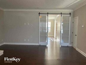 Charlotte house for rent - an empty living room with a sliding glass door