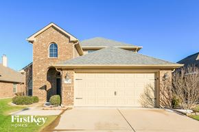 Fort Worth house for rent - A house with a garage door that says FirstKey Homes.