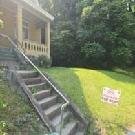 Cincinnati house for rent - A house with a staircase leading to the front door.