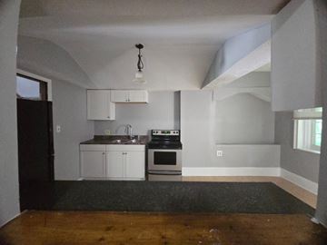 Cincinnati house for rent - A kitchen with a stove top oven and a sink.
