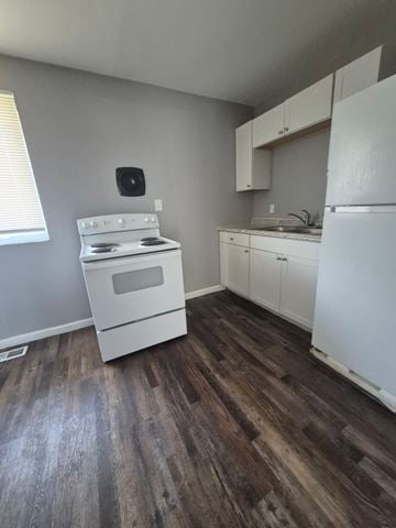 Cincinnati apartment for rent - A kitchen with a white stove and white fridge.