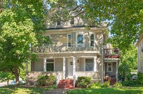 Minneapolis apartment for rent - a white house with a porch and trees