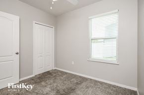 Kissimmee house for rent - the bedroom of a home with carpet and a window