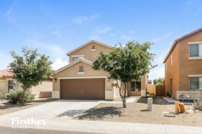 Maricopa house for rent - a house with a driveway and a garage door