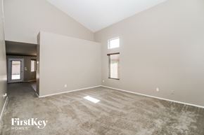 Maricopa house for rent - an empty living room with carpet and a window