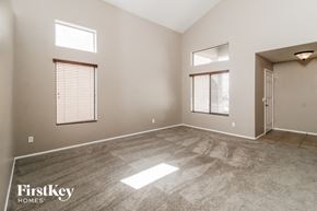 Maricopa house for rent - an empty living room with a door and two windows