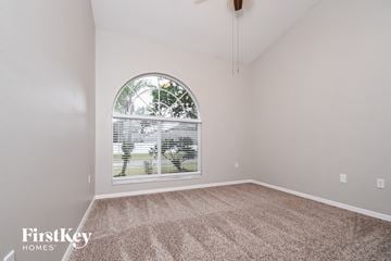 Valrico house for rent - the living room of a home with a large window and carpet