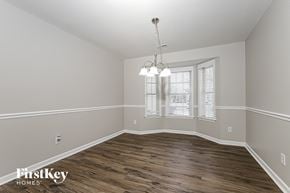 Greensboro house for rent - the spacious living room with hardwood flooring and a chandelier