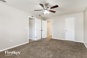Winter Haven house for rent - a living room with carpet and a ceiling fan