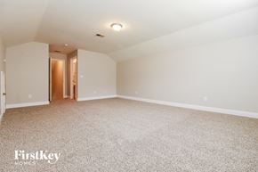 Moncks Corner house for rent - A spacious room with a carpeted floor and a doorway leading to another room.