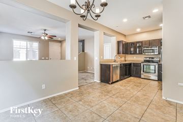 Gilbert house for rent - A kitchen with a tile floor and a chandelier.