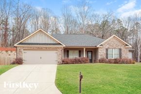 Pendergrass house for rent - A house with a grey roof and a white garage door.