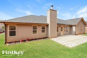 Pendergrass house for rent - A house with a brown exterior and a stone pathway leading to the front door.
