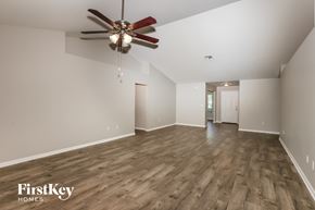 Lehigh Acres house for rent - a living room with a ceiling fan and hardwood floors