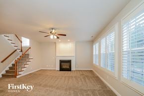 Jamestown house for rent - A spacious living room with a fireplace and a staircase.