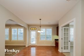 Jamestown house for rent - A well-lit, spacious room with a chandelier hanging from the ceiling.