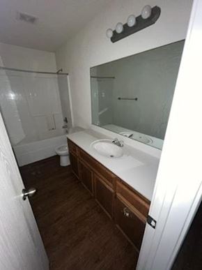 Killeen apartment for rent - a bathroom with a sink and a toilet and a mirror