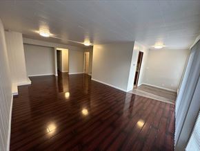 Bellevue apartment for rent - an empty living room with wooden floors and white walls