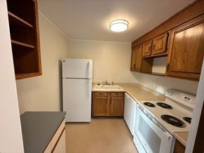 Bellevue apartment for rent - a kitchen with white appliances and wooden cabinets