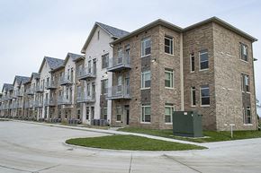Ames apartment for rent - A row of new apartment buildings with a green lawn in front.
