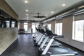 Ames apartment for rent - A gym with treadmills and a fan.