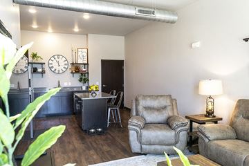 Ames apartment for rent - A living room with a grey couch, a grey chair and a grey armchair.