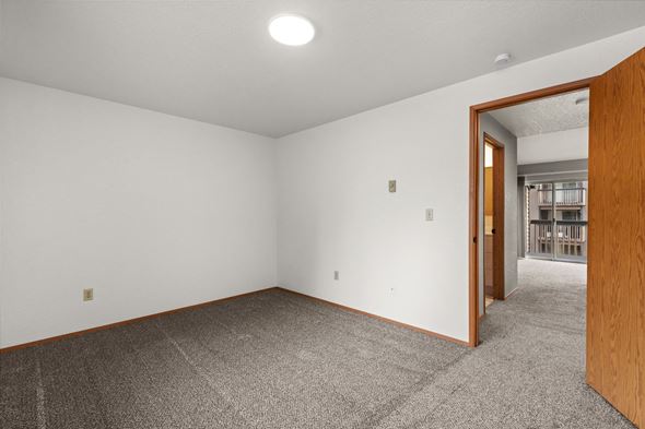 Tacoma apartment for rent - a living room with carpet and a door to a hallway