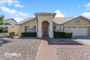 Mesa house for rent - a house with a driveway and a garage door