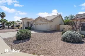 Mesa house for rent - a home with a driveway and a garage door