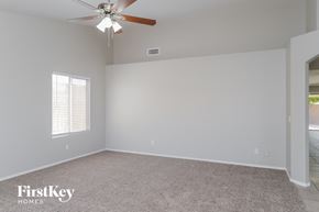 Mesa house for rent - a bedroom with a ceiling fan and a carpeted floor