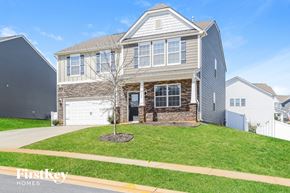 Mooresville house for rent - a house with a lawn and a sidewalk in front of it