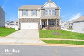 Mooresville house for rent - a suburban house with a white garage door and a lawn