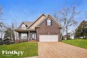 Gallatin house for rent - A brick house with a garage and a driveway in front.