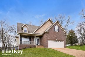 Gallatin house for rent - A house with a brick facade and a white garage door is for sale.